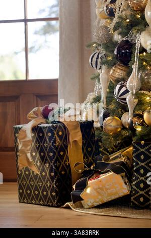 Gifts wrapped under a Christmas tree Stock Photo