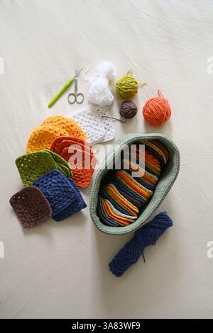 Crocheted squares blanket in making, multi-colored granny square Stock Photo