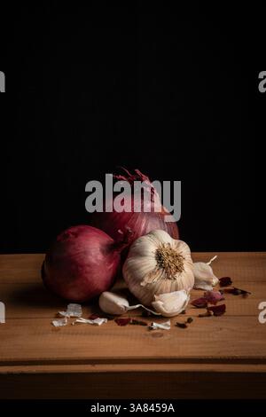red onions and garlic on a black background Stock Photo