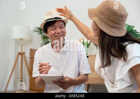 Creativity and Fun in Retirement. A senior man enjoying a playful moment with his partner while discussing travel plans. Stock Photo