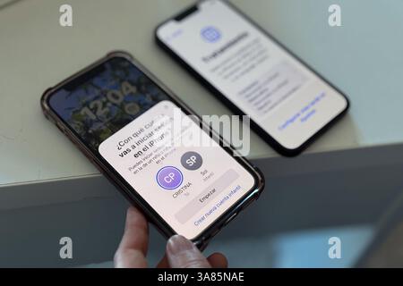 Close up of the hands of a woman synchronizing a brand new iPhone 16e with the old one Stock Photo