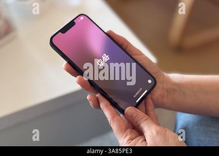 Close up of the hands of a woman unboxing a brand new iPhone 16e Stock Photo