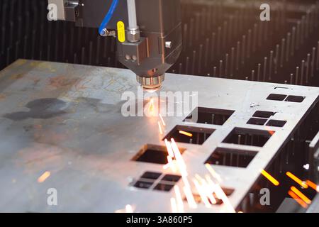 Metal machining with sparks on CNC laser cutting of the metal. Laser cutting Stock Photo
