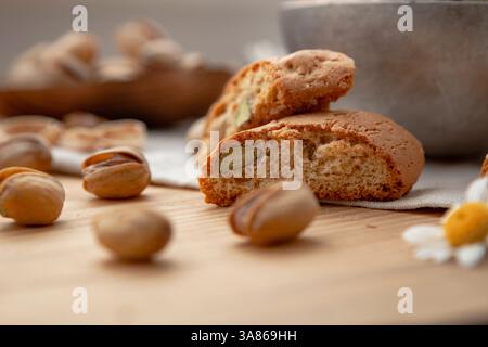 Pistachios and some cantucci on a wooden table Stock Photo