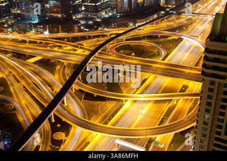 Night traffic on a busy intersection on Sheikh Zayed highway, Dubai, United Arab Emirates Stock Photo