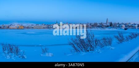 View of the city skyline of Reykjavik from Tjornin lake at sunset in winter, Reykjavik, Iceland Stock Photo