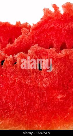 Pieces of ripe juicy red watermelon with seeds close-up on white background Stock Photo