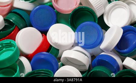 Plastic bottles caps close up recycling and reuse concept background. Stock Photo
