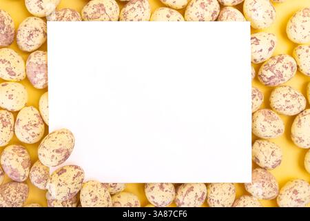 Blank white postcard among quail easter eggs Stock Photo