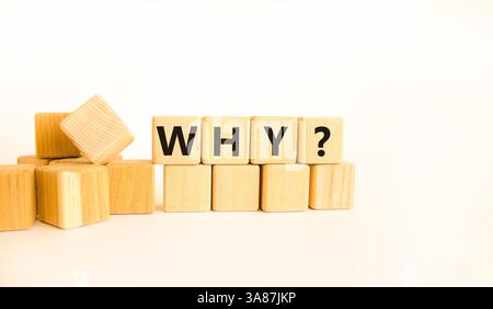 Why question symbol. Concept word Why question on beautiful wooden blocks. Beautiful white table white background. Business, lifestyle, support and wh Stock Photo