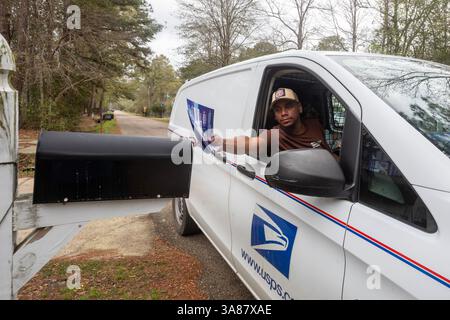 Covington, Louisiana - A letter carrier delivers mail from a U.S. Postal Service vehicle. Stock Photo