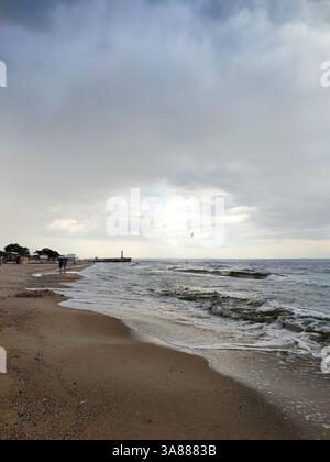 Rain and storm at sea. Dark storm clouds, rain and sea surface. Nature. Natural background. Stormy weather. Storm at sea. Big rain clouds Stock Photo