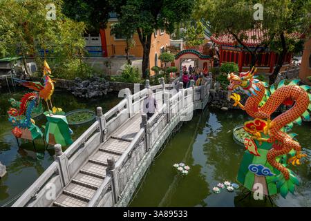 Hong Kong. China- 02.24.2025.High angle view of the traditional Chinese style stone bridge and dragon, phoenix, installation on the pond of Good Wish Stock Photo