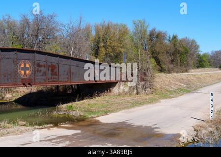 Rusty, old rail bridge used to span a creek in oil field area in West Texas. Now only used when needed by motor vehicles and pedestians. Stock Photo