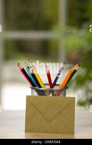 Colored pencils in a stand. Office. Envelope on the table. Envelope and colored pencils. High quality photo Stock Photo
