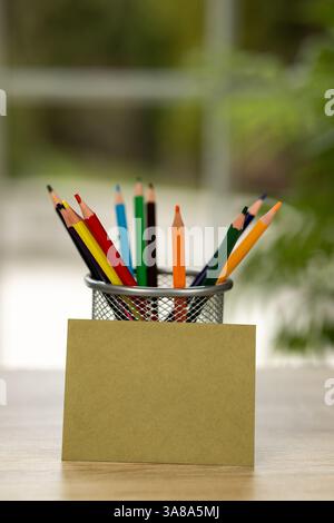 Colored pencils in a stand. Office. Envelope on the table. Envelope and colored pencils. High quality photo Stock Photo