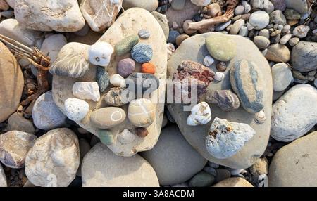 Various shapes and colors of stones on the riverbank Stock Photo