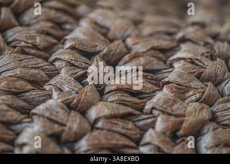 Close-up of a woven brown fiber texture, showcasing intricate patterns and natural material, ideal for backgrounds and design projects. Stock Photo