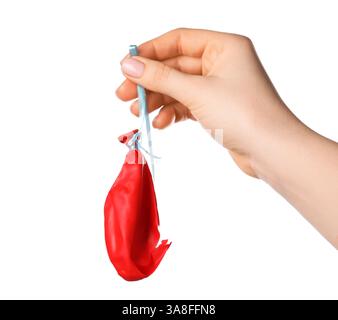 Woman holding popped red balloon on white background, closeup Stock Photo