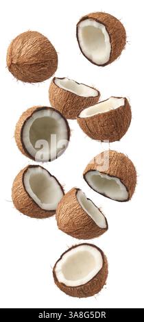 coconuts cut in half falling isolated white background, brown fibrous husk and inner white flesh visible, abundance and freshness concept Stock Photo