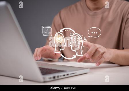 Human and AI interaction in modern technology. A person using a laptop with virtual assistant and deep learning, representing intelligent automation a Stock Photo