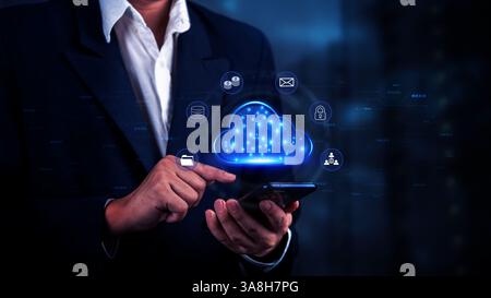 businessman using a smartphone to interact with a digital cloud interface, cloud computing, and data storage. data sharing in business operations. dig Stock Photo