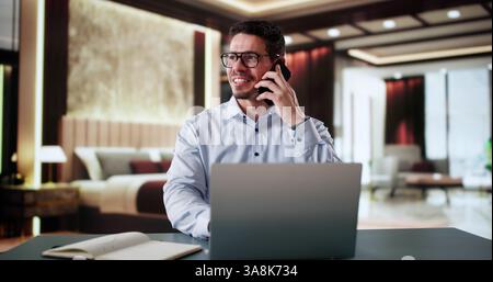 Entrepreneur Man In Hotel On Business Travel Vacation Using Mobile phone Stock Photo