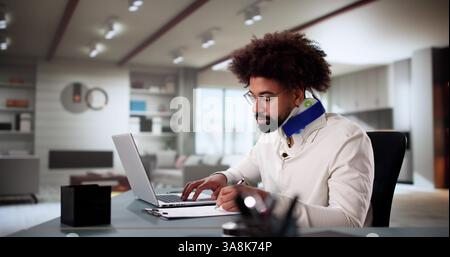 Injured Worker Compensating for Broken Arm by Working from Home Stock Photo