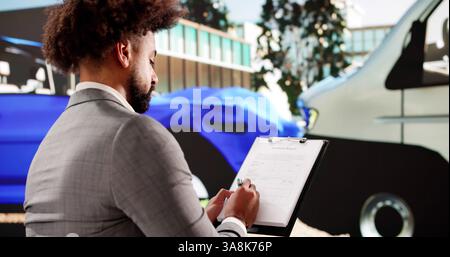 African American Insurance Agent Inspects Car Damage After Accident Stock Photo