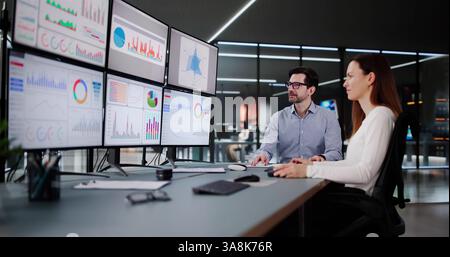 Financial Advisor Analyzing Stock Market Data on Desktop Computer Screen. Stock Photo