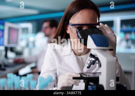 Science lab researchers analyzing vaccine development using advanced technology and equipment. Stock Photo
