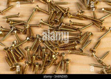 golden metal self tapping screws for construction work, beautiful new metal fasteners self tapping screws for connecting wooden or metal elements Stock Photo