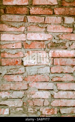 A brick wall is a sturdy structure made of bricks and mortar. It provides privacy, security, and aesthetic appeal to buildings. durability and timeles Stock Photo