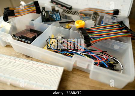 Electronics components, Breadboard in box with jumper wires and breadboard, symbolizing DIY projects, circuit building, electronic prototyping, hobby Stock Photo