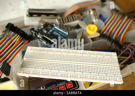 Electronics components, Breadboard in box with jumper wires and breadboard, symbolizing DIY projects, circuit building, electronic prototyping, hobby Stock Photo