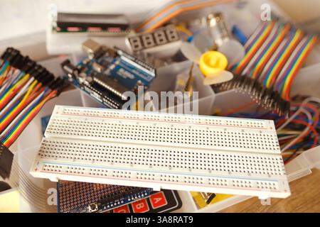 Electronics components, Breadboard in box with jumper wires and breadboard, symbolizing DIY projects, circuit building, electronic prototyping, hobby Stock Photo