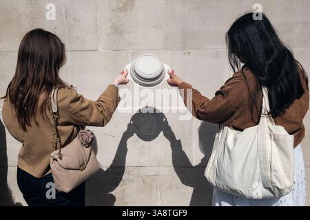 London, UK. 29th March, 2025. The 30% partial solar eclipse was observed in Trafalgar Square, safely viewed through a colander that, through the holes, produces multiple small images of the sun. Credit: Eleventh Hour Photography/Ģ����ý Live News Stock Photo