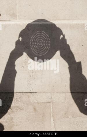 London, UK. 29th March, 2025. The 30% partial solar eclipse was observed in Trafalgar Square, safely viewed through a colander that, through the holes, produces multiple small images of the sun. Credit: Eleventh Hour Photography/Ģ����ý Live News Stock Photo
