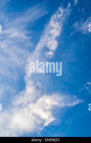Different shapes and forms of white clouds in a blue sky. Stock Photo