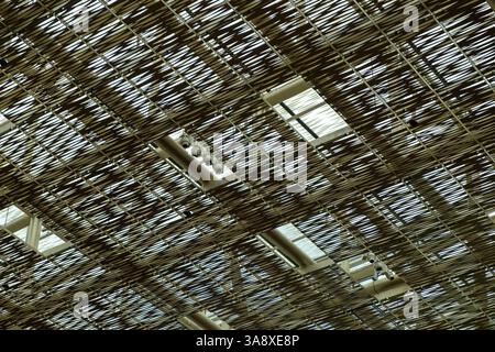Decorative metal ceiling or roof structure featuring an intricate, crisscross pattern of thin metallic strips Stock Photo
