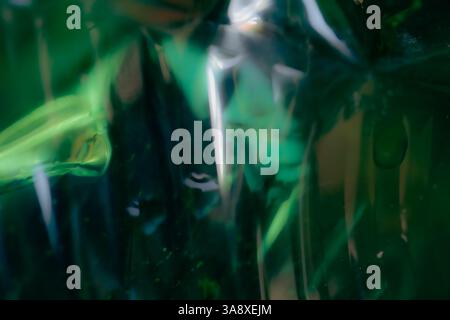 Defocused shiny plastic texture, abstract background, green tones Stock Photo