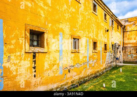Historic crumbling walls with barred windows in Ushuaia, Argentina. Stock Photo