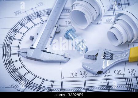 Stainless bolt with nut adjustable spanner trammel caliper construction drawings on blueprint architecture and building concept Stock Photo