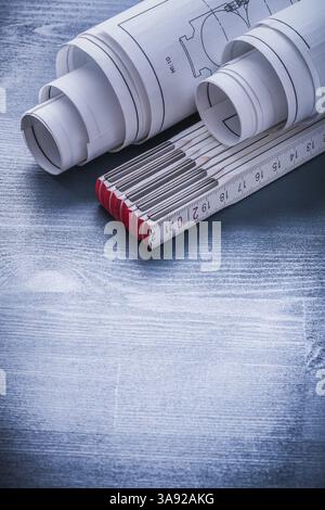 vertical version two rolls of blueprints and white wooden meter Stock ...