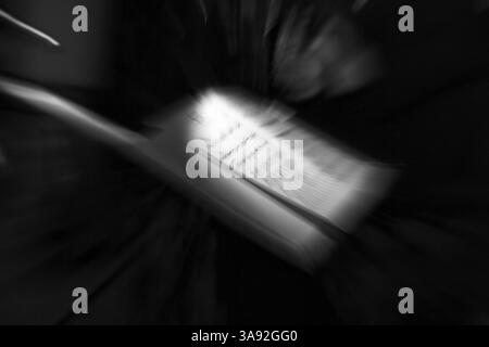 Illuminated sheet of music, music stand on a stage, milonga, tango dance event, concert, motion blur, monochrome, Germany, Europe Stock Photo