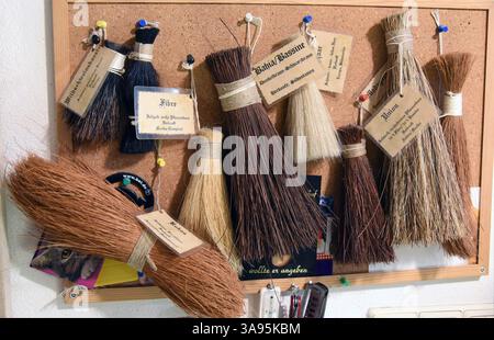 FILED - 10 October 2018, Saxony-Anhalt, Naumburg: In brush maker Ursula Römer's small store, Bürstenmanufaktur Steinbrück, various tufts of bristle hair hang on the wall. In her traditional store, which her great-grandfather opened in 1885, the 79-year-old still makes large and small brushes, brooms, paintbrushes, hand brushes and feather dusters by hand from a wide variety of bristles. The many cleaning tools now also include record brushes. The brushes are made with a beechwood handle and thousands of fine Chinese goat hairs. The small store has already been described by the New York Times a Stock Photo