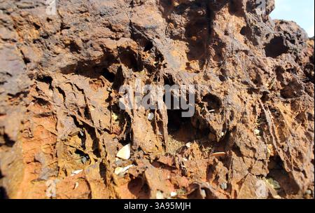 Close up textured abstract background of an orange brown rock stone Stock Photo