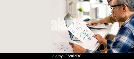 Group of asian senior in a collaborative software development analyzing  flowcharts  during a bootcamp training Stock Photo