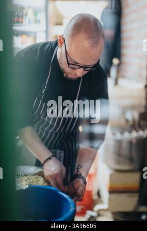 Chef preparing dishes in professional kitchen during a dedicated cooking session Stock Photo