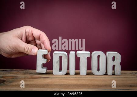 EDITOR Word Created from Concrete Alphabet Letters on Wooden Desk. Stock Photo